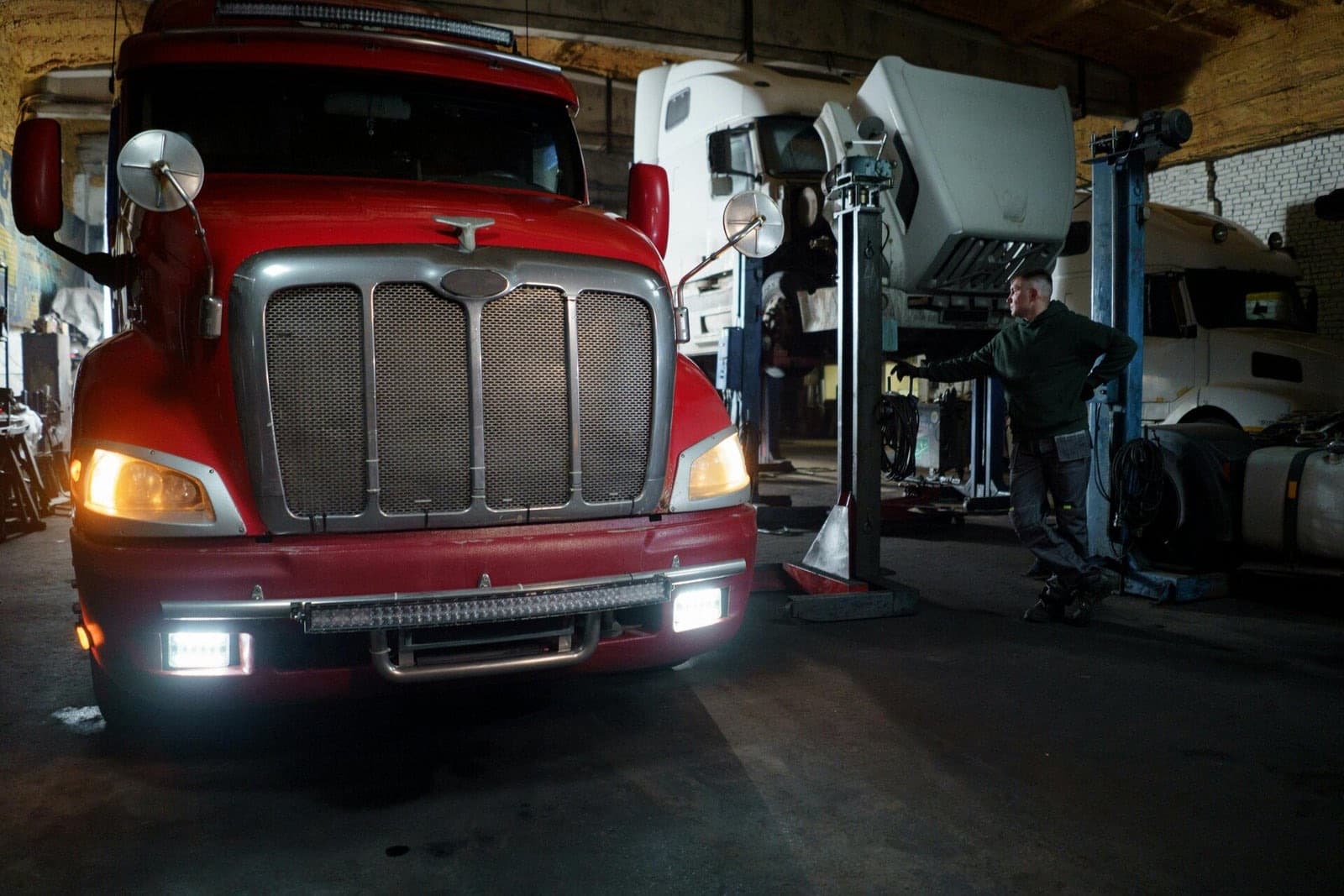 Mechanic repairing a heavy-duty truck in a service bay